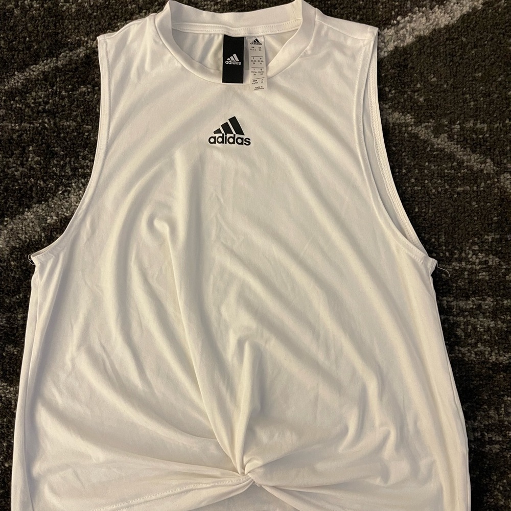 Adidas Cute workout tank. Cute bottom detail. Never worn . NWOT.
